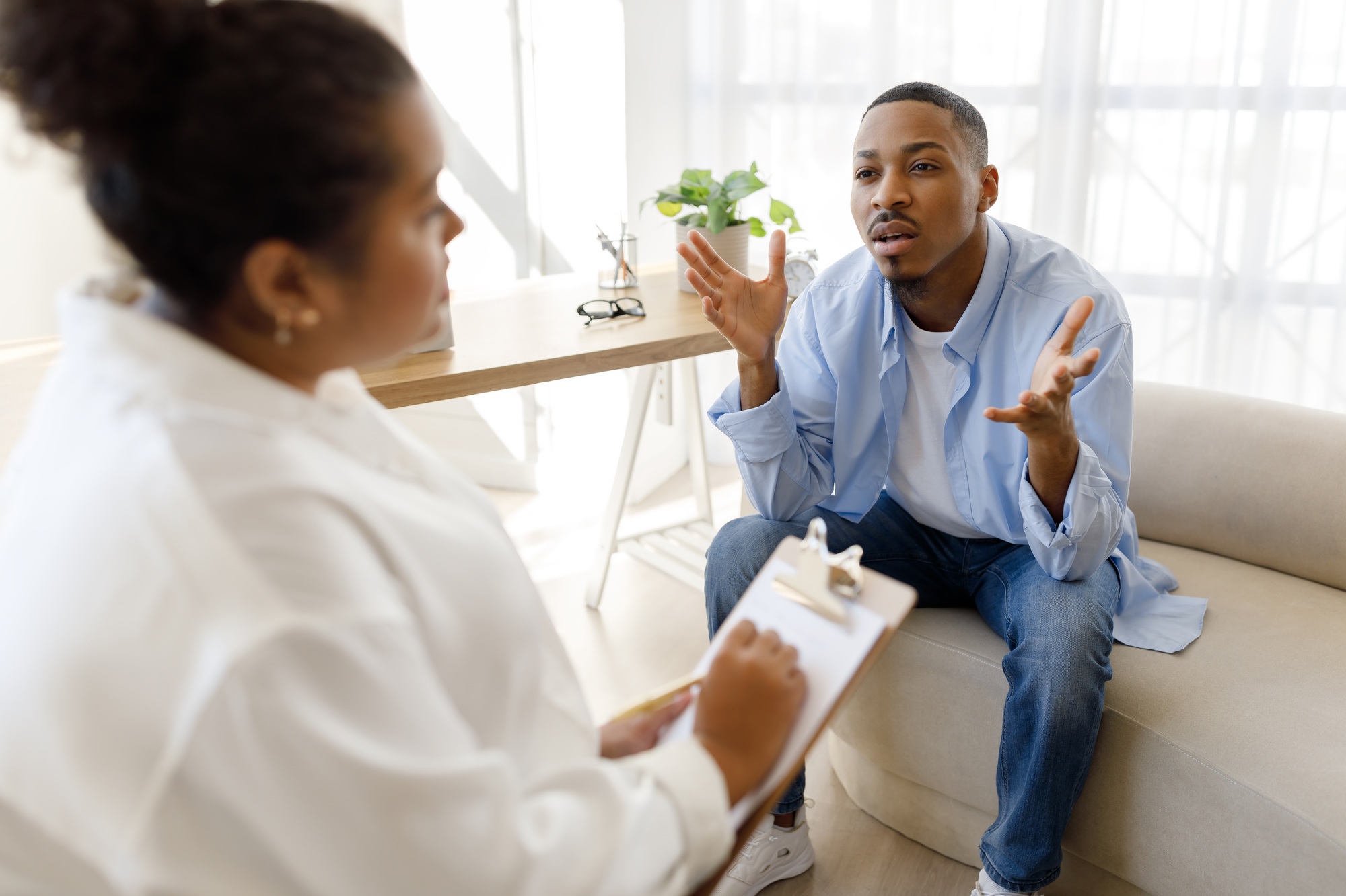Anxious black man experiencing midlife crisis, have therapy session