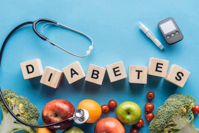 diabetes lettering made of wooden cubes with medical equipment and fruits on blue background