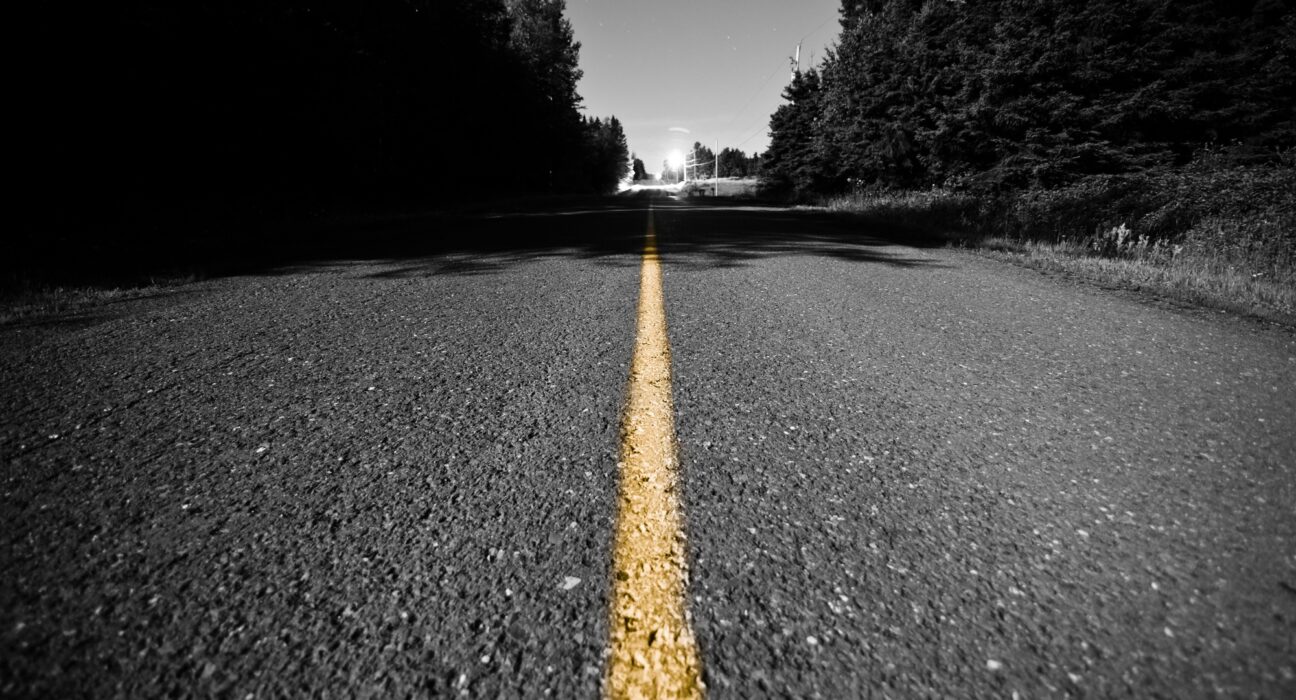 Empty road with Yellow Dividing line at Night