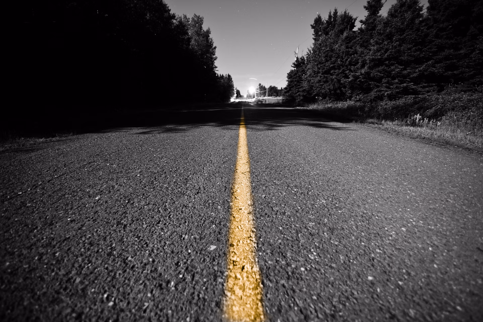 Empty road with Yellow Dividing line at Night