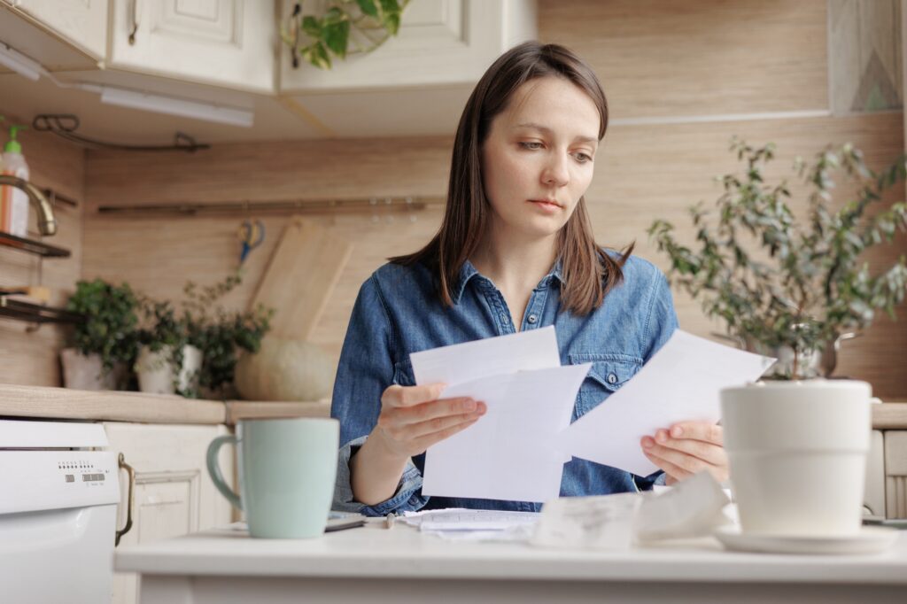 financial literacy and loan repayment. a woman counts on a calculator the amount of monetary income