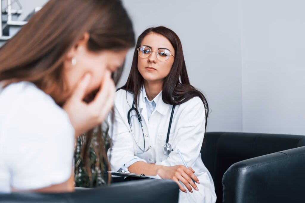 Girl have mental breakdown and crying. Young woman have a visit with female doctor in modern clinic