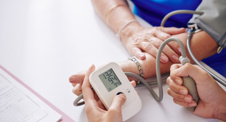 Measuring blood pressure of elderly woman