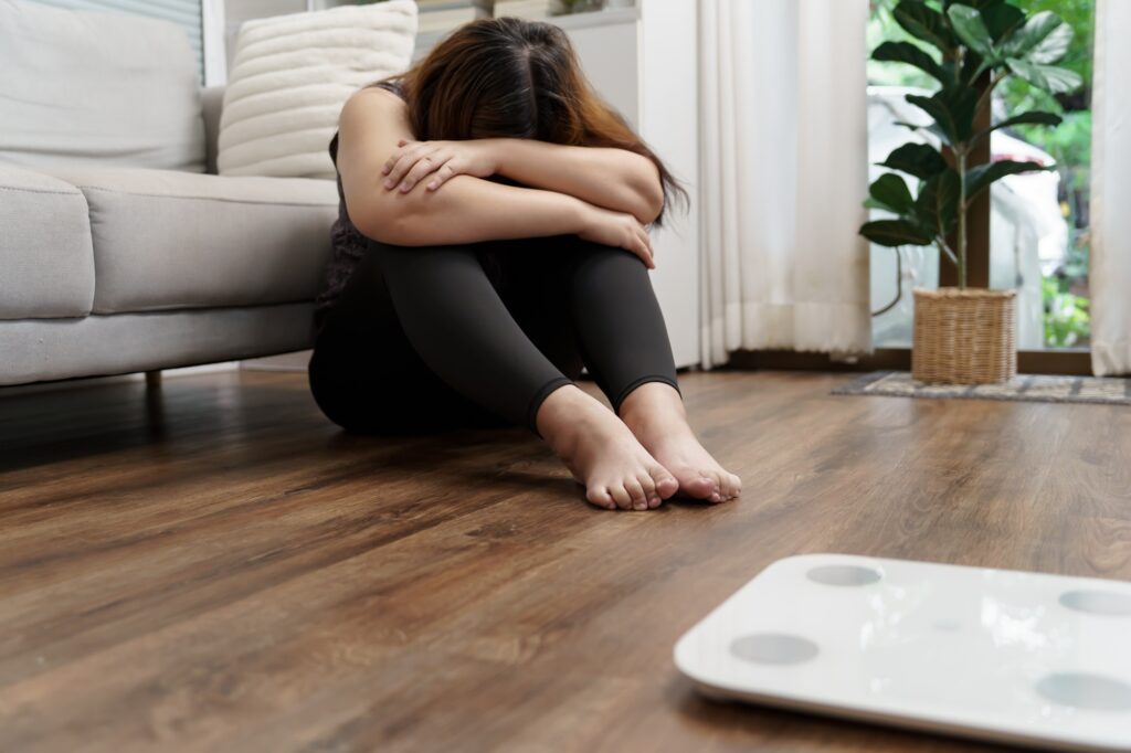 Sad woman with fat upset bored of dieting Weight loss fail  Fat diet and scale sad asian woman