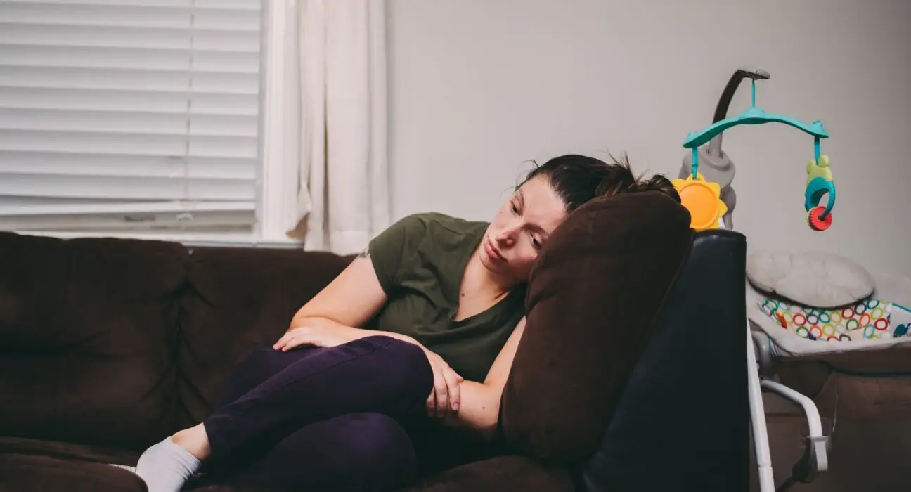 A mother who is feeling lonely, tired and sad. Postpartum depression, anxiety, motherhood