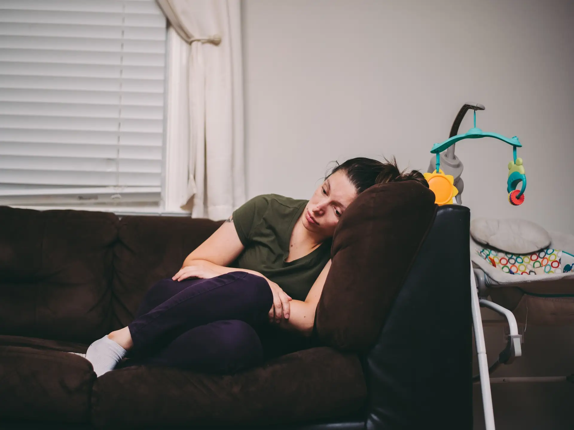 A mother who is feeling lonely, tired and sad. Postpartum depression, anxiety, motherhood