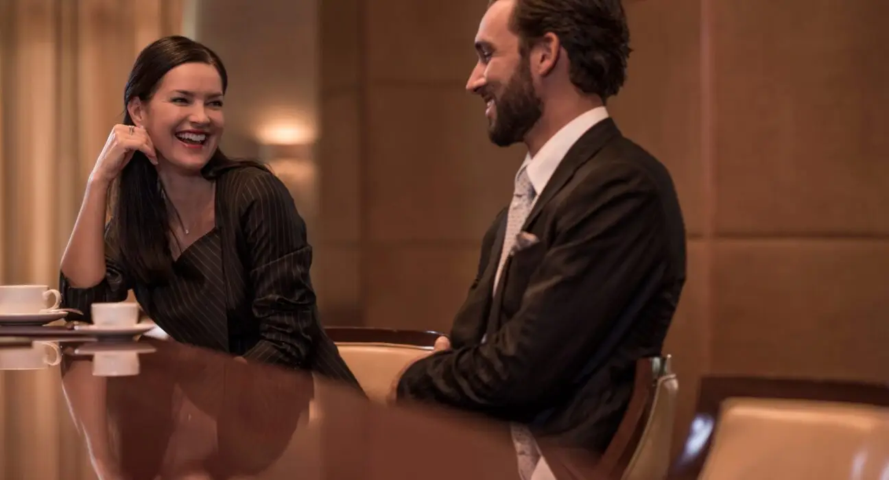 Businesswoman and man flirting at hotel bar