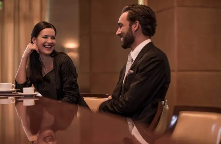 Businesswoman and man flirting at hotel bar