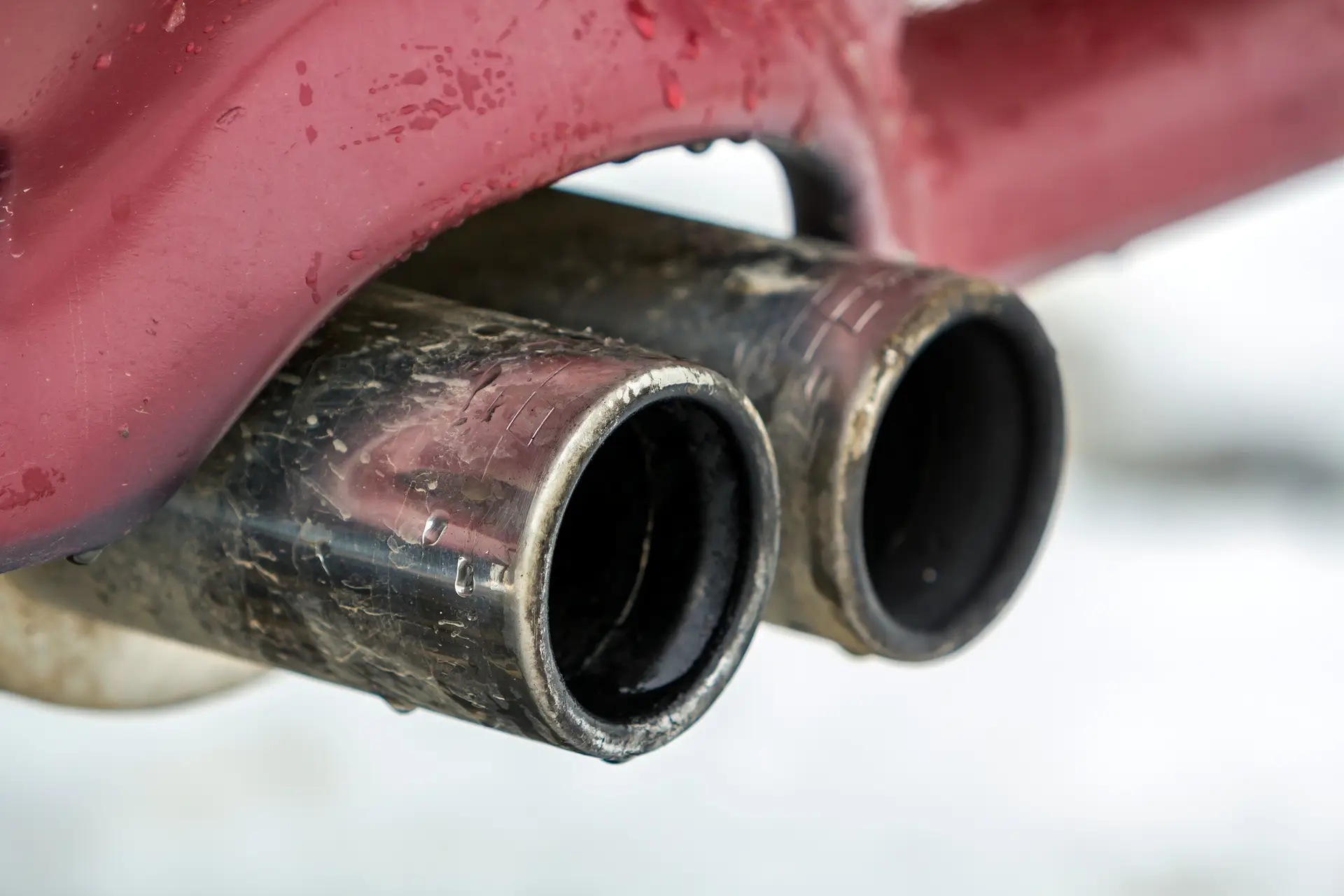 Close up image of a car dual exhaust pipe. Emission of poisonous carbon monoxide gas