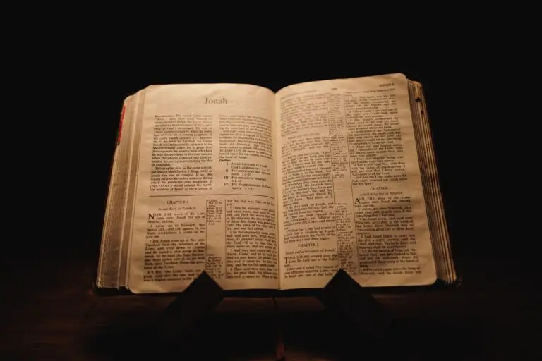 Closeup shot of a historic old Bible open on the Jonah pages on display in a dark room