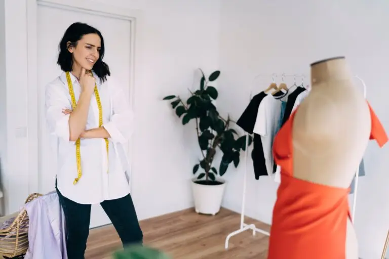 Female dressmaker looking doubtfully at dress