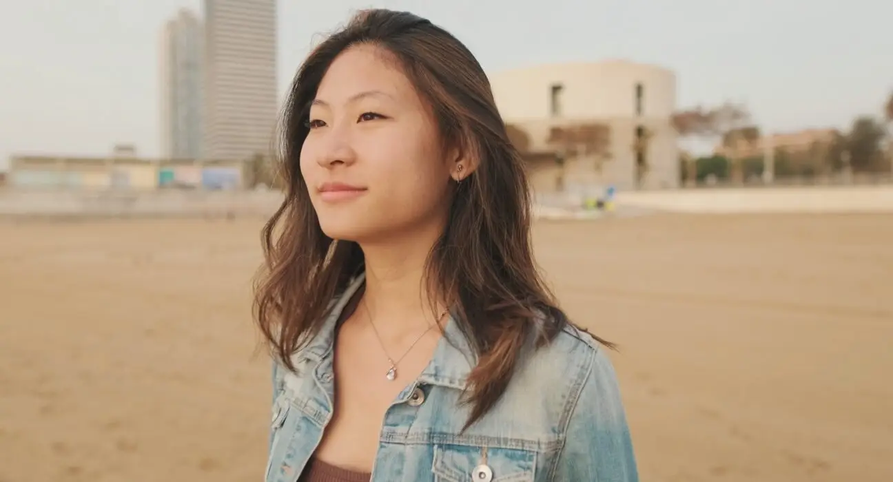 Young beautiful woman walking on the beach