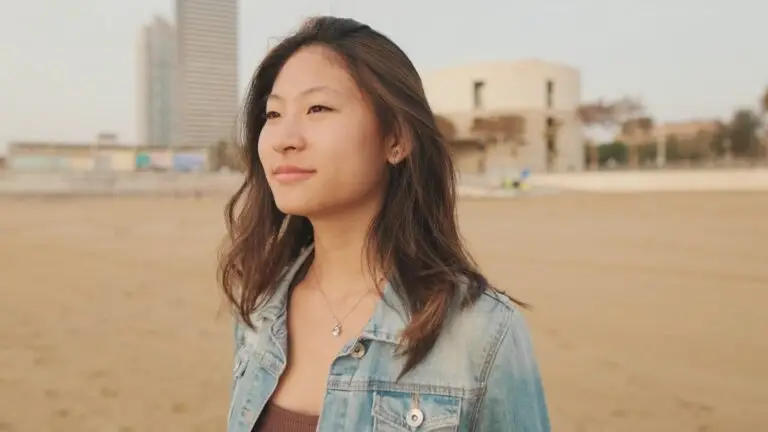 Young beautiful woman walking on the beach
