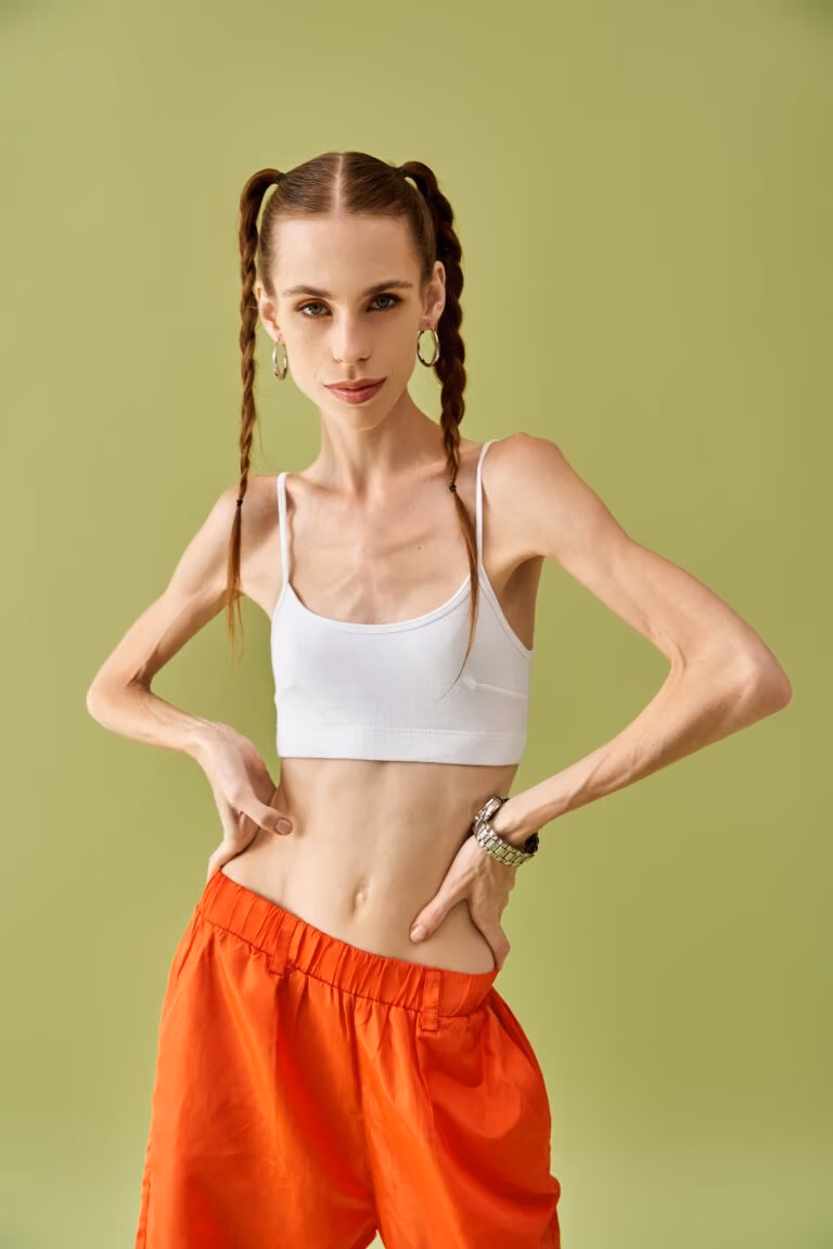 Young woman expressing her struggle with anorexia in a colorful setting