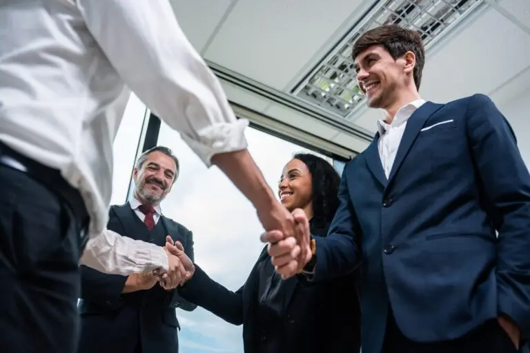 Caucasian businessman making a handshake together while stand in office.