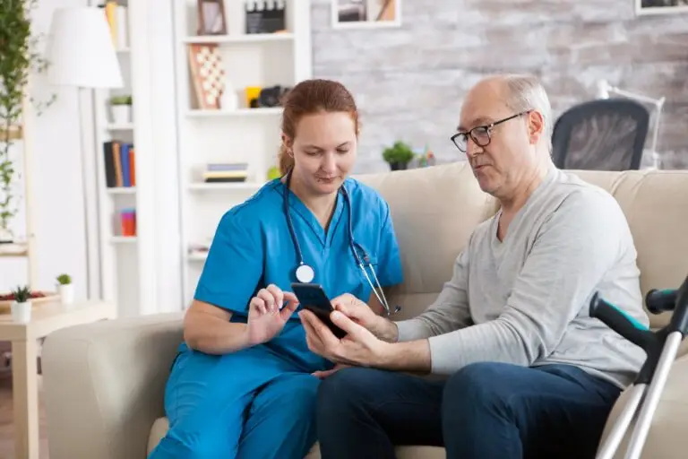 Female doctor in nursing home showing old man